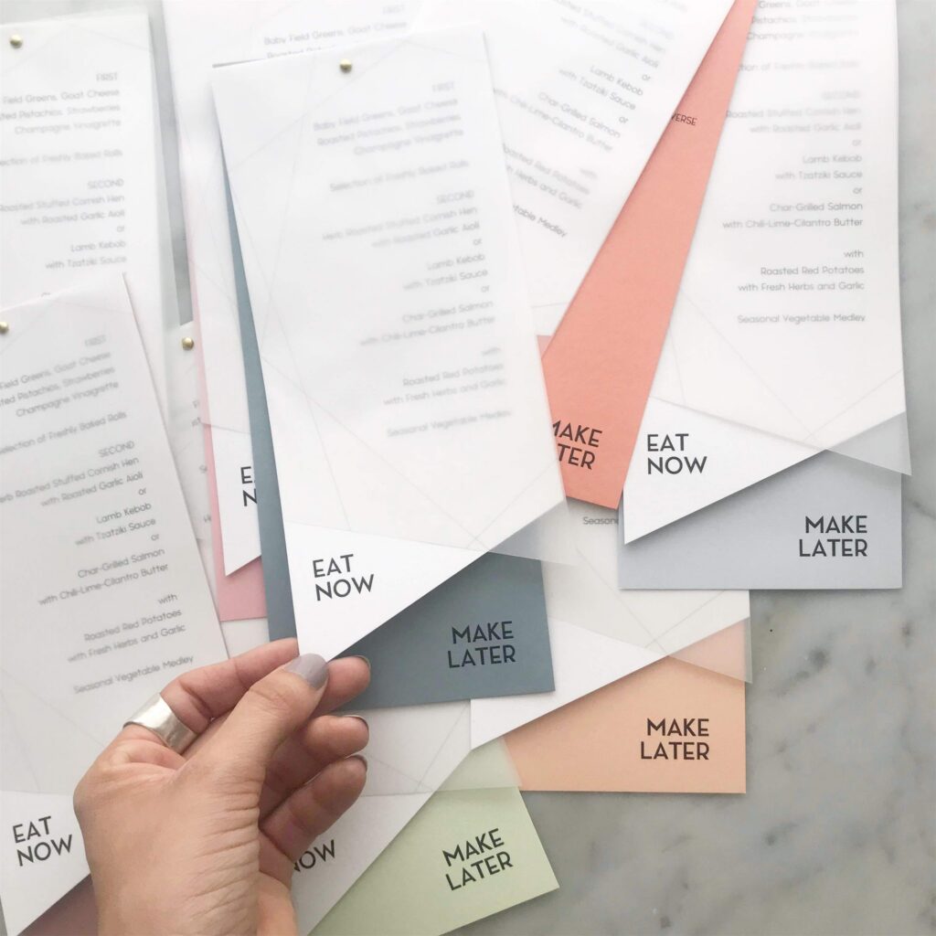 Layered wedding menu printed by Cards and Pockets featuring vellum, white cardstock, and multiple cardstock backing colors.